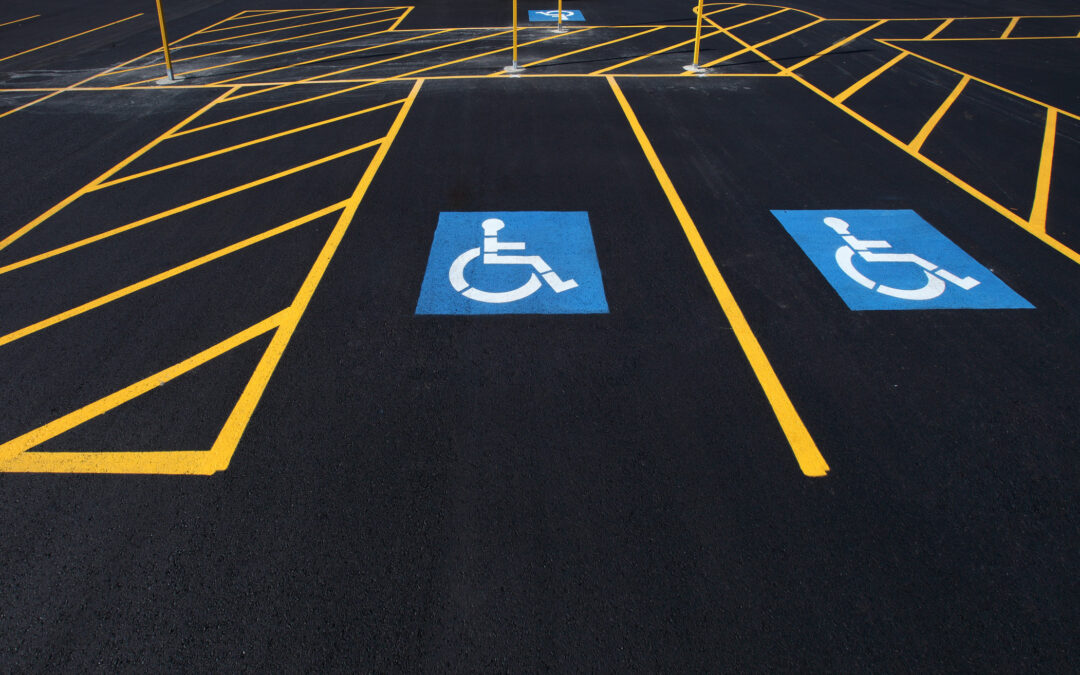 Freshly painted parking lot in Orange County with ADA-compliant markings, including accessible parking spaces, completed by BuiltPro Painting.